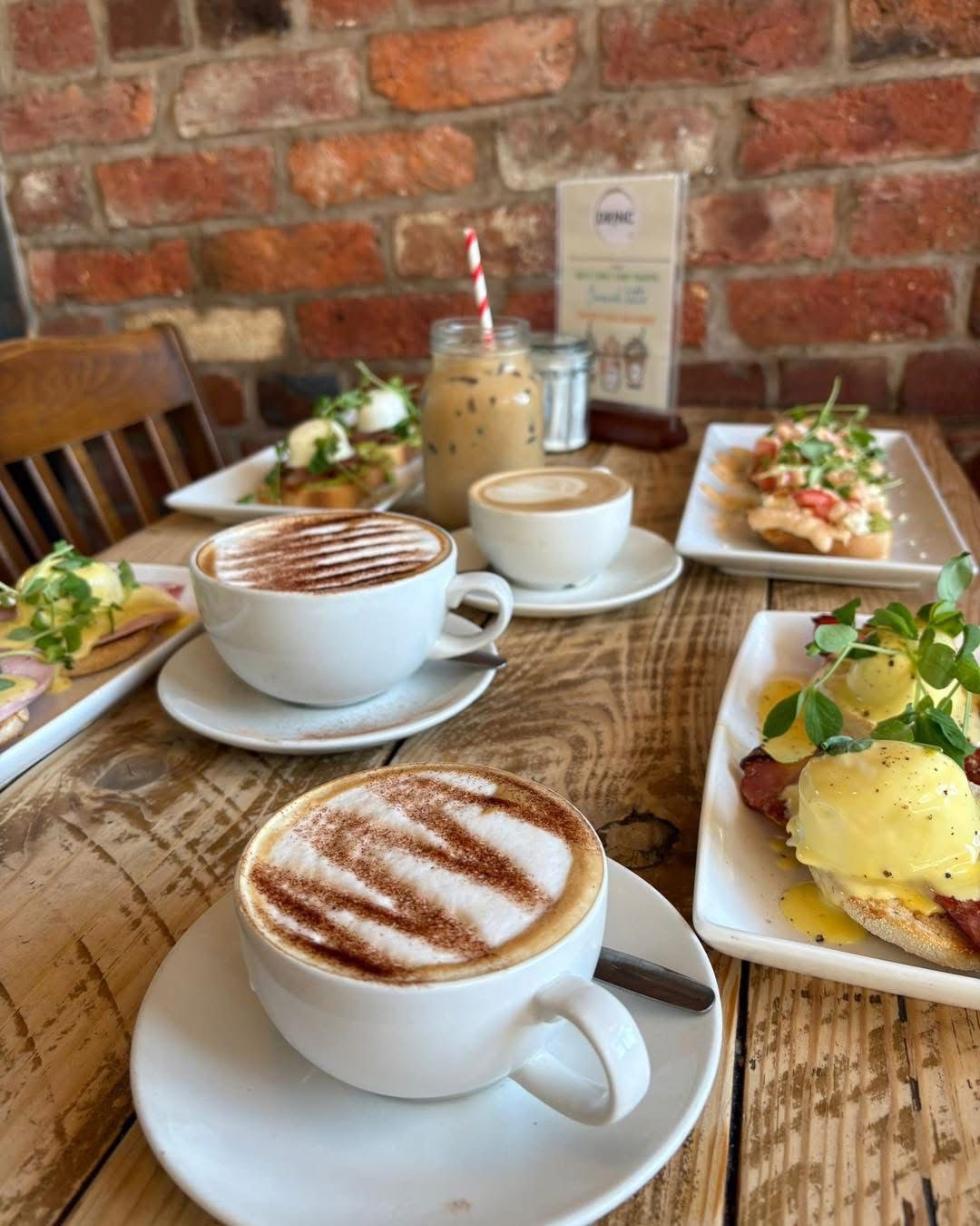 Brunch spread with cappuccinos and eggs benedict at DRINC Coffee Bar Ramsbottom