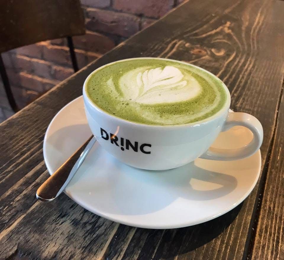 Matcha latte with latte art in DRINC branded cup Ramsbottom